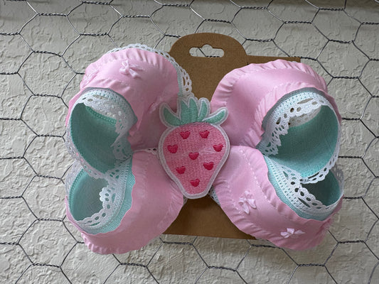 Pink and teal lace bow with pink strawberry in center